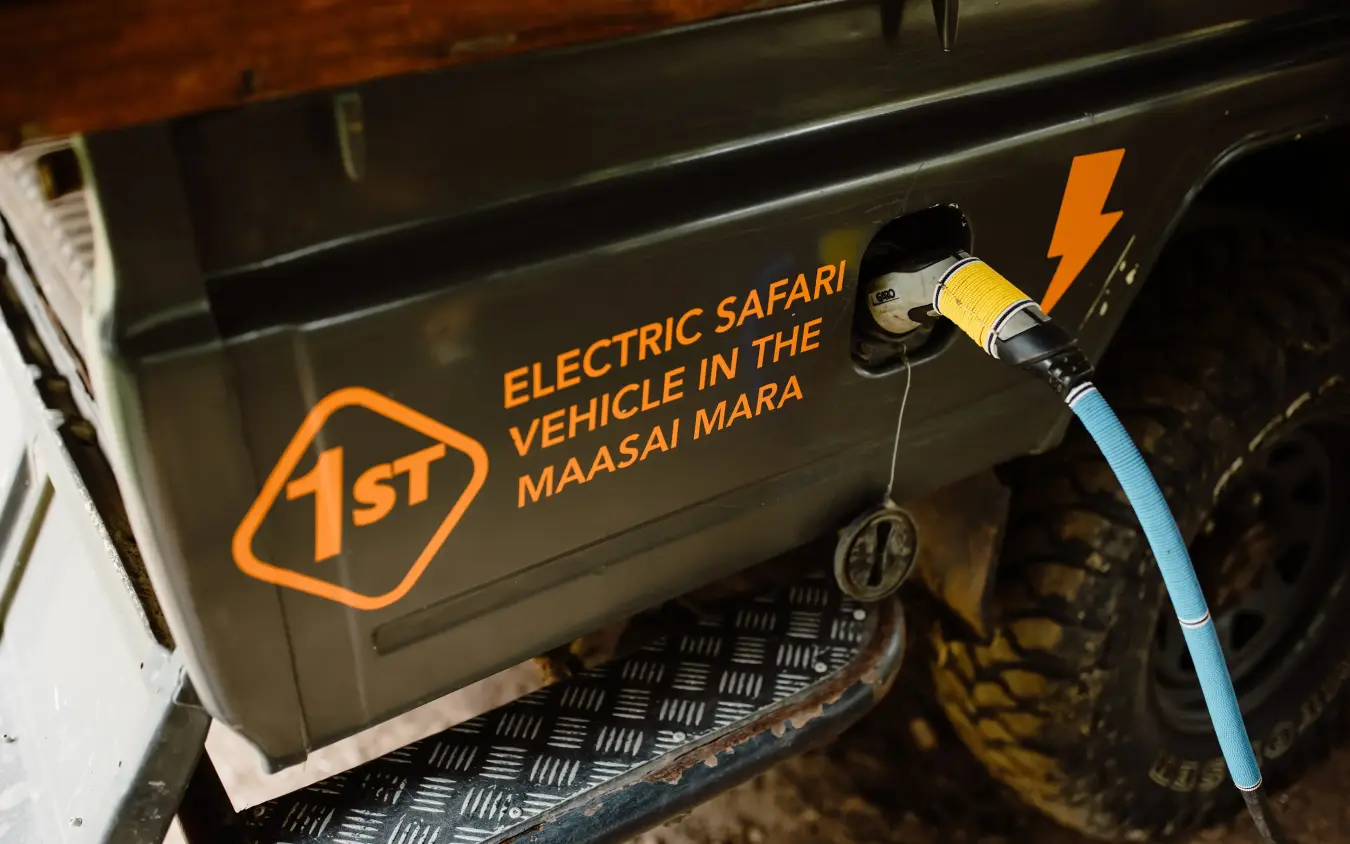 Electric safari vehicle charging cable connected to vehicle, Emboo Camp, Maasai Mara, Kenya