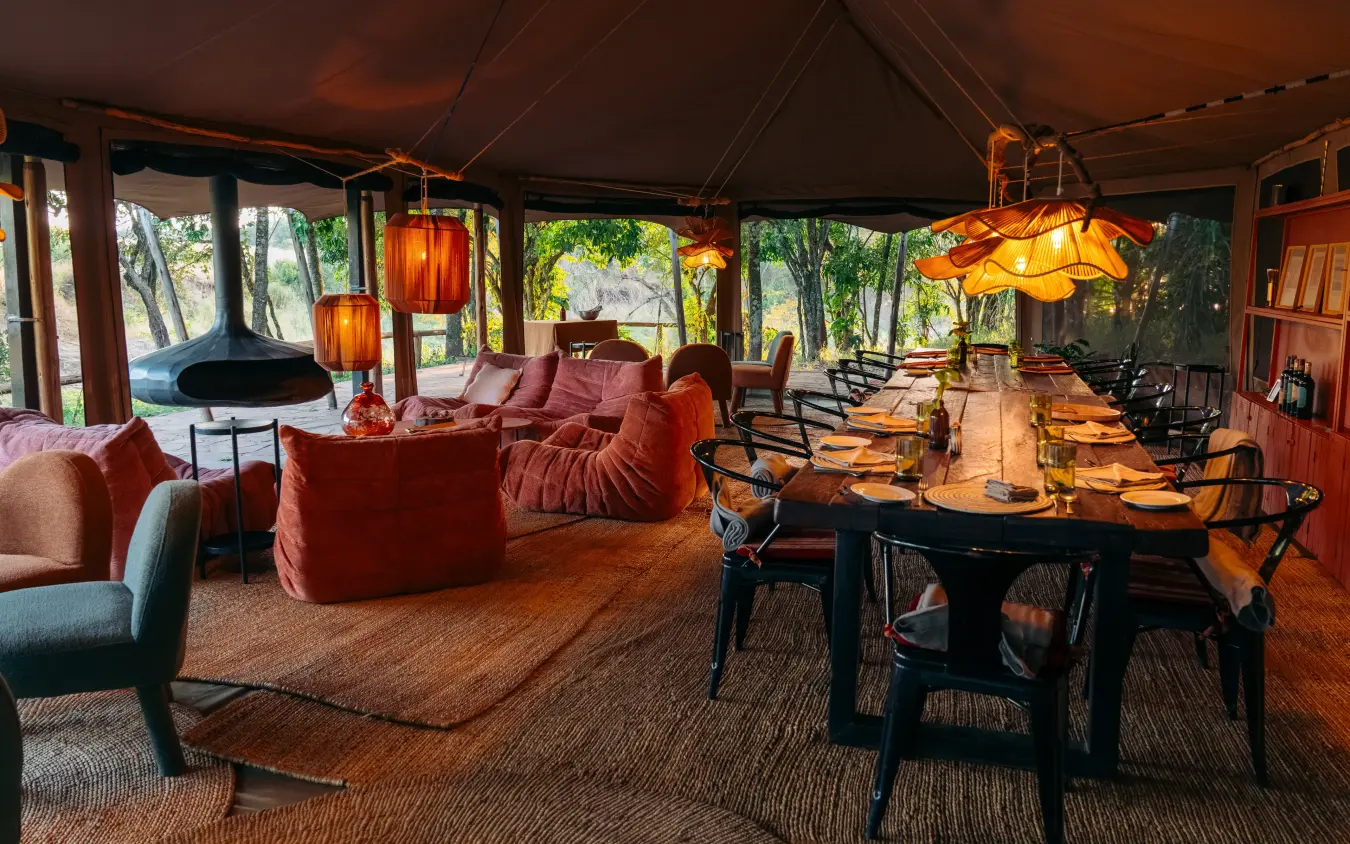 Open-plan lounge and dining area with warm wood furnishings, Emboo Camp, Maasai Mara, Kenya