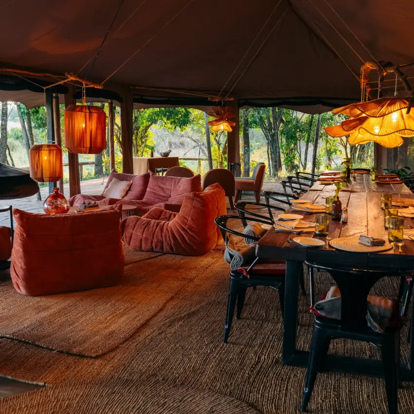 Open-plan lounge and dining area with warm wood furnishings, Emboo Camp, Maasai Mara, Kenya