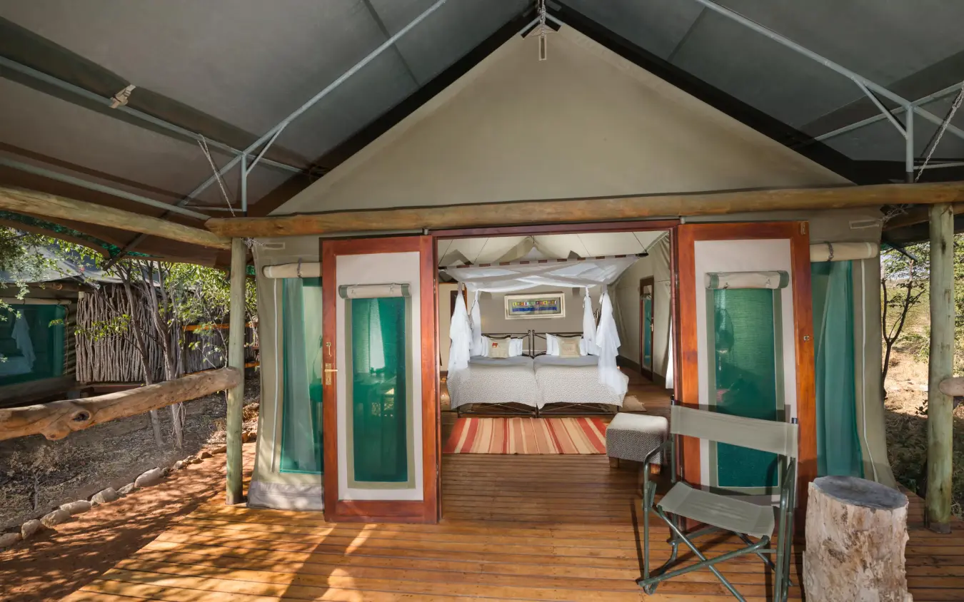 Tented guest room with double bed and open veranda, Encounter by Ongava, Etosha National Park, Namibia