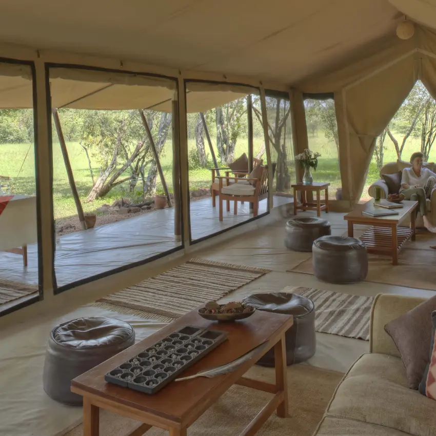 Canvas tent lounge with floor-to-ceiling windows overlooking savanna, Encounter Mara Camp, Maasai Mara, Kenya