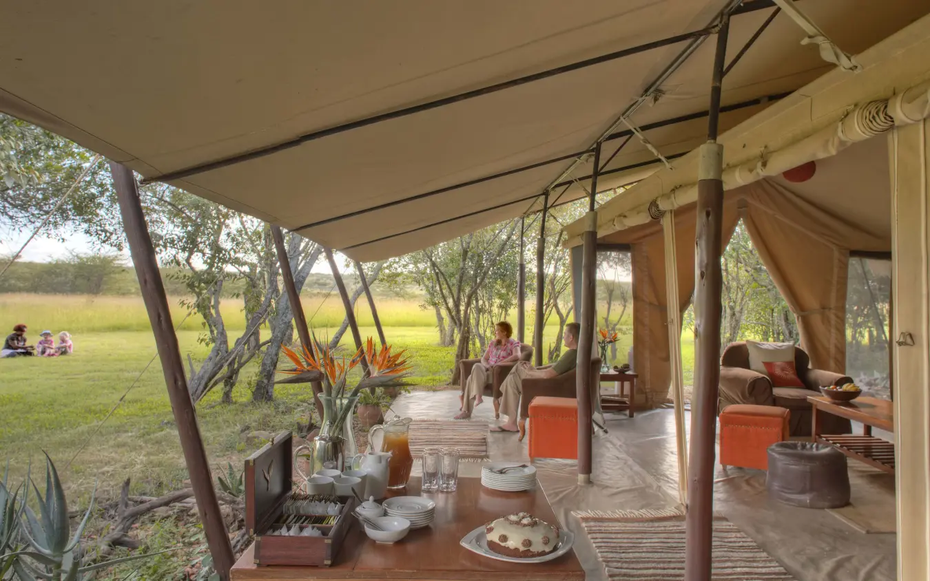 Open-sided lounge pavilion overlooking savanna grassland, Encounter Mara Camp, Maasai Mara, Kenya