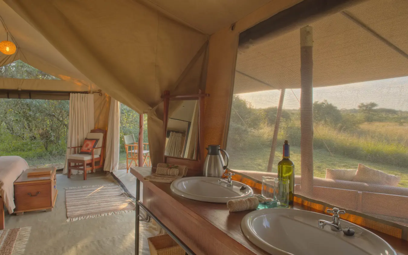 Safari tent interior with dual sinks overlooking grassland, Encounter Mara Camp, Maasai Mara, Kenya