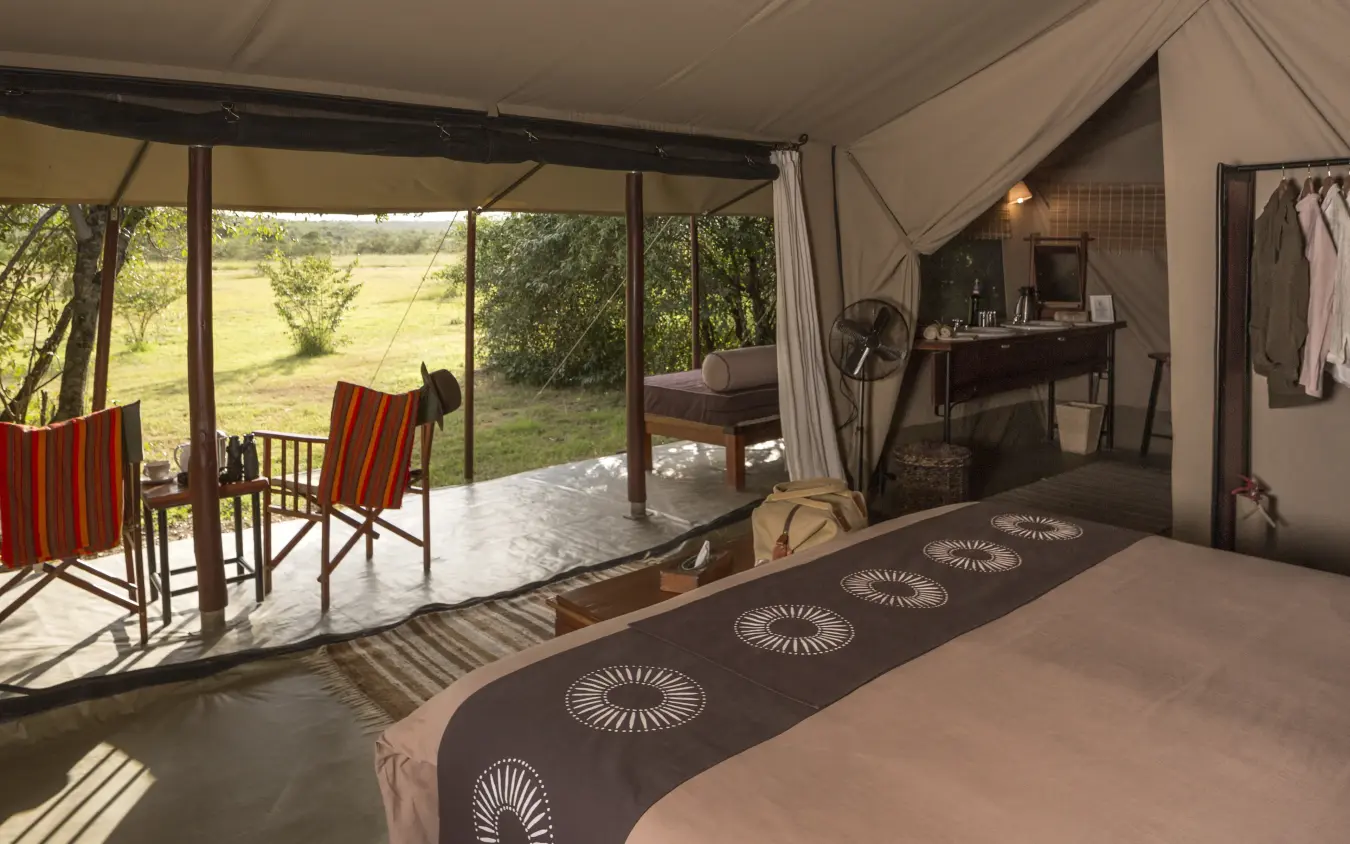 Safari tent bedroom with open views of grassland landscape, Encounter Mara Camp, Maasai Mara, Kenya