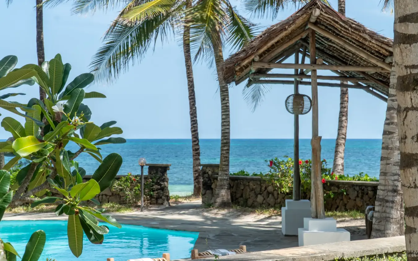 Beachfront resort pool with ocean view and thatched roof pavilion, Enkare Bofa, Kilifi, Kenya