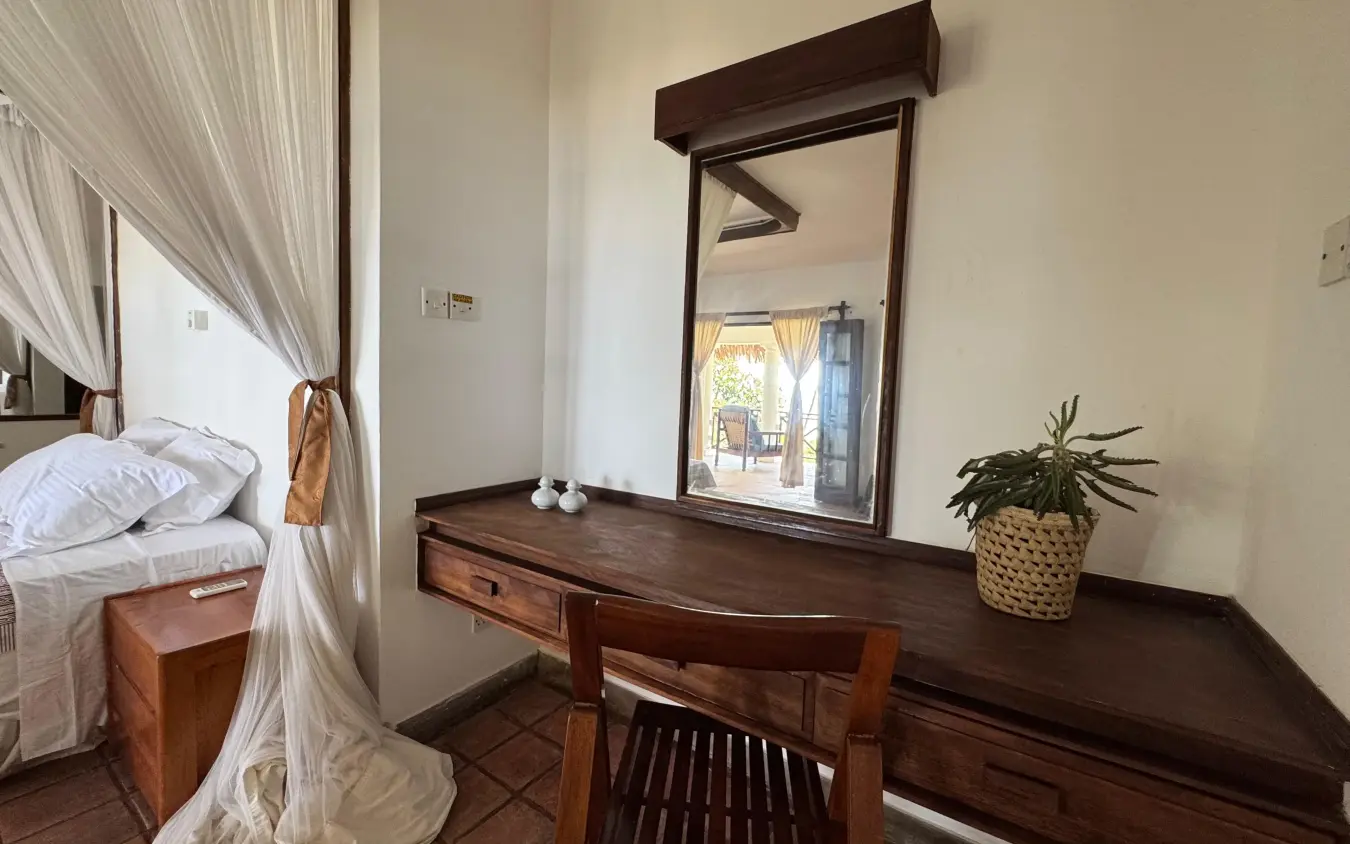 Bedroom vanity with mirror and potted plant overlooking terrace, Enkare Bofa, Kilifi, Kenya