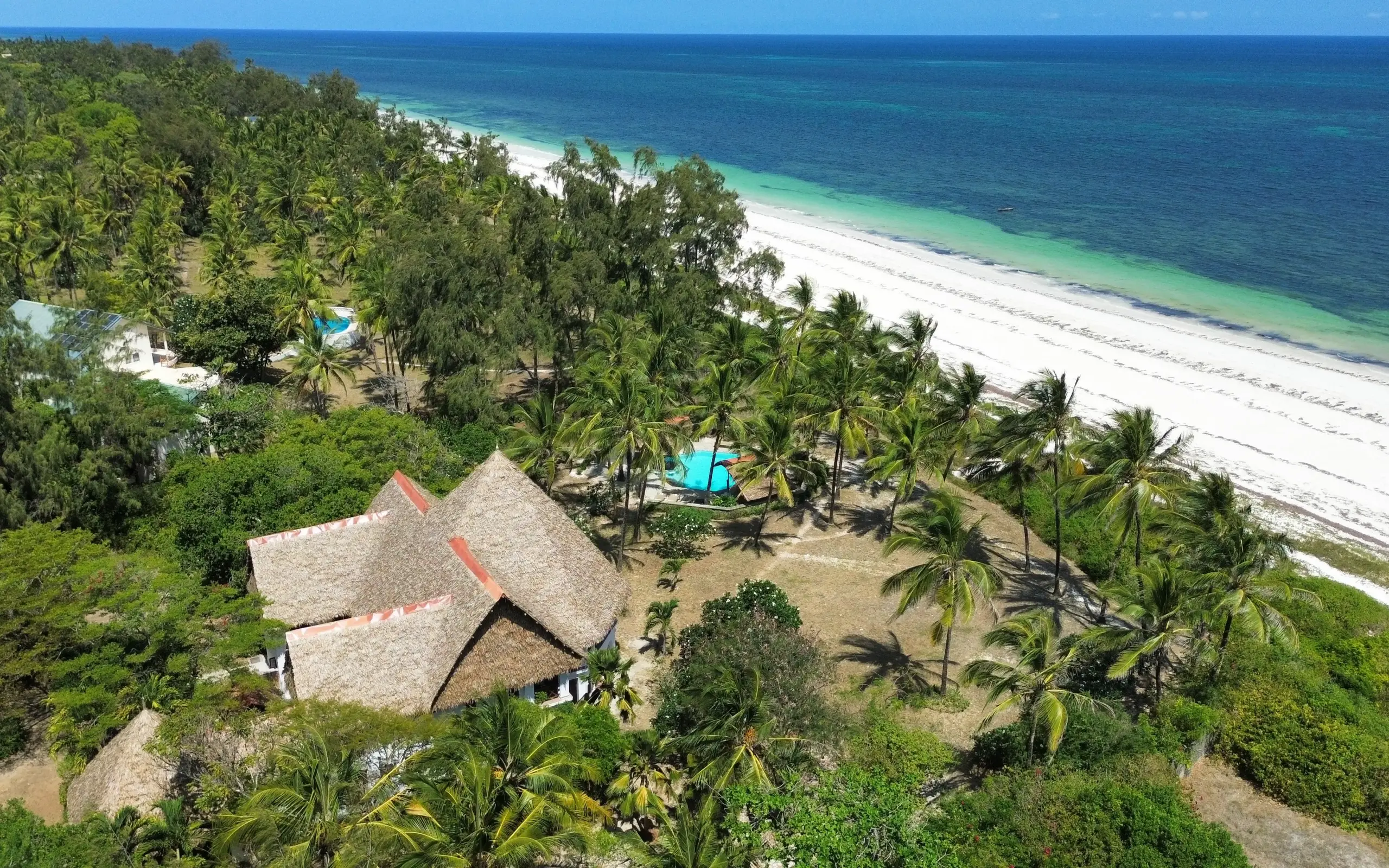 Beachfront lodge with thatched roof overlooking turquoise waters and white sand beach, Enkare Bofa, Kilifi, Kenya