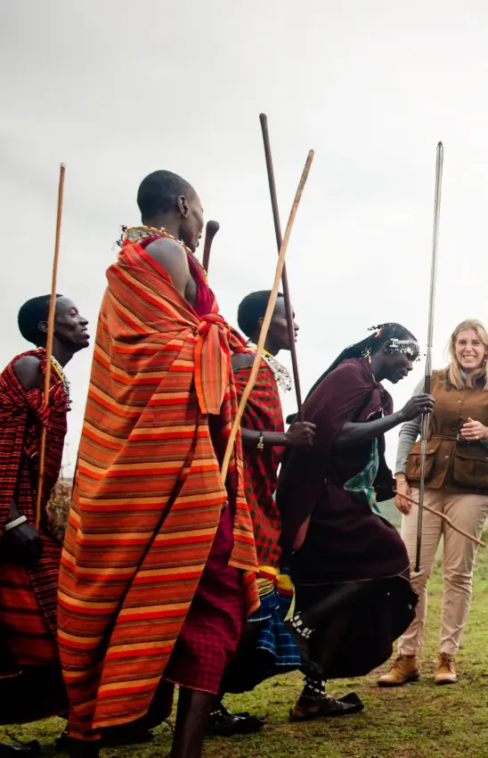 Maasai warriors greeting tourists in traditional clothing, Entamanu Camp, Ngorongoro Crater, Tanzania