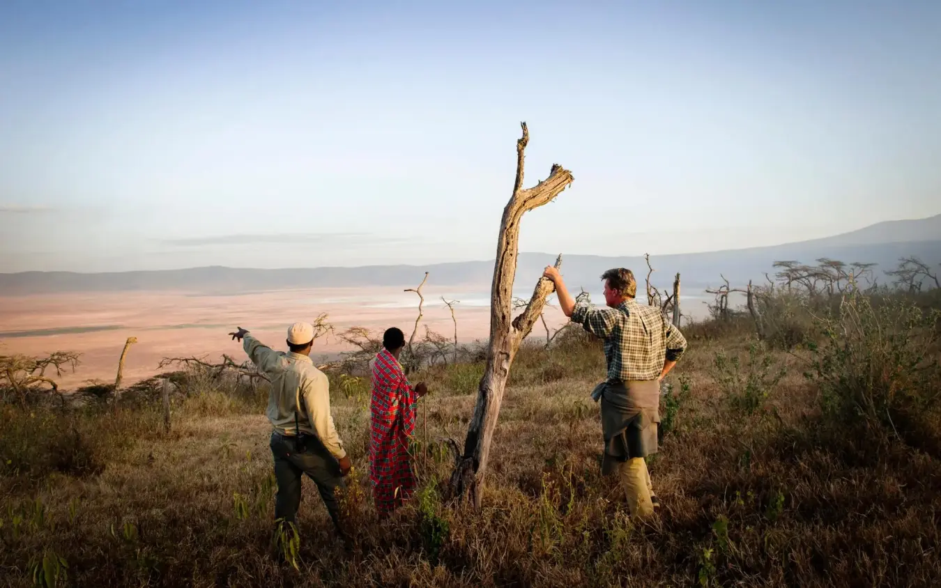 Guides pointing out features across expansive valley landscape, Entamanu Camp, Ngorongoro Crater, Tanzania