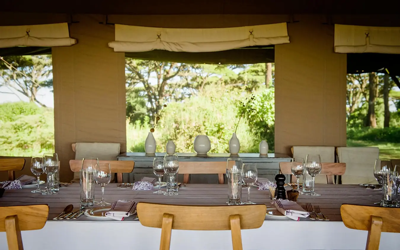 Open-air dining pavilion with table settings and landscape views, Entamanu Camp, Ngorongoro Crater, Tanzania