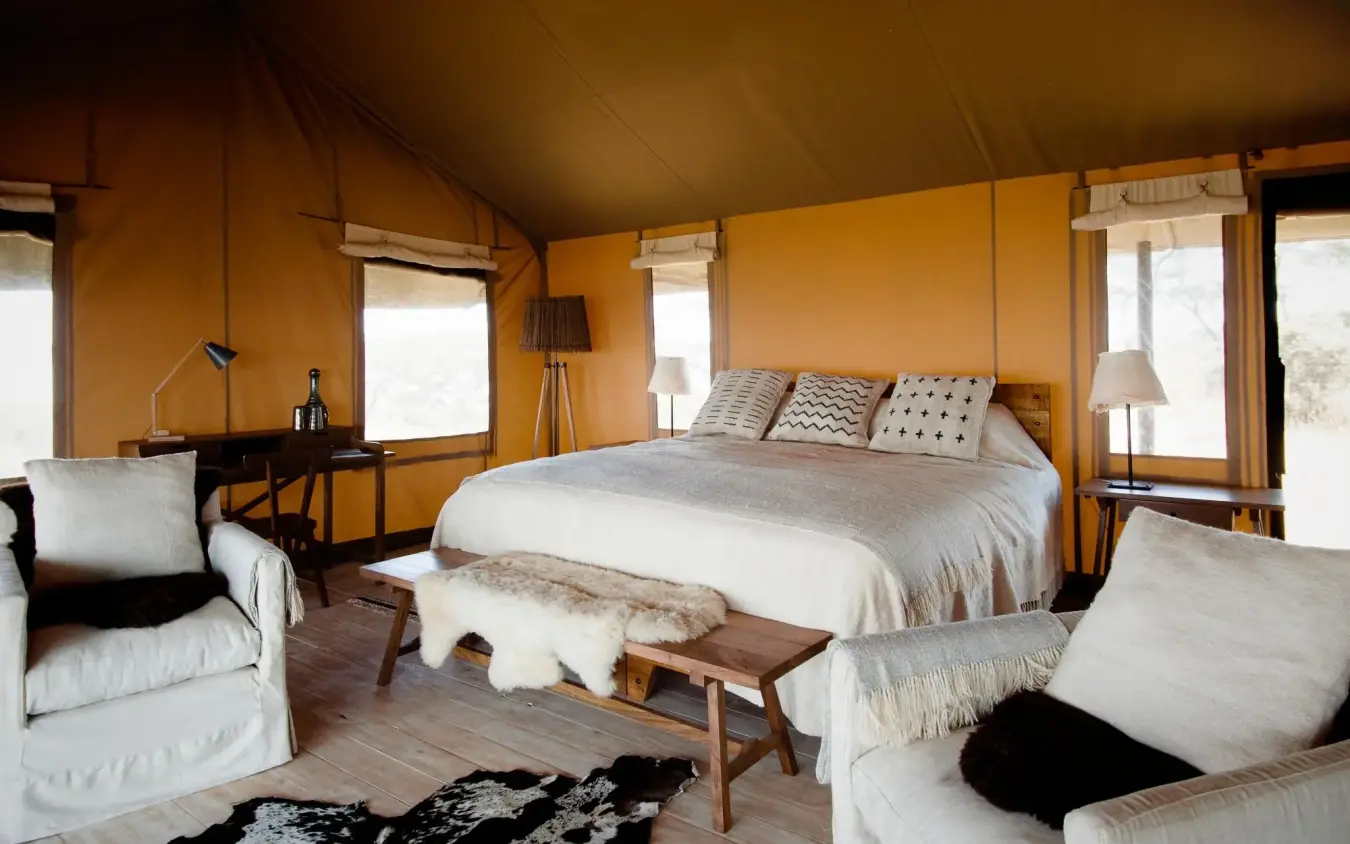 Safari tent bedroom with queen bed and seating areas, Entamanu Camp, Ngorongoro Crater, Tanzania