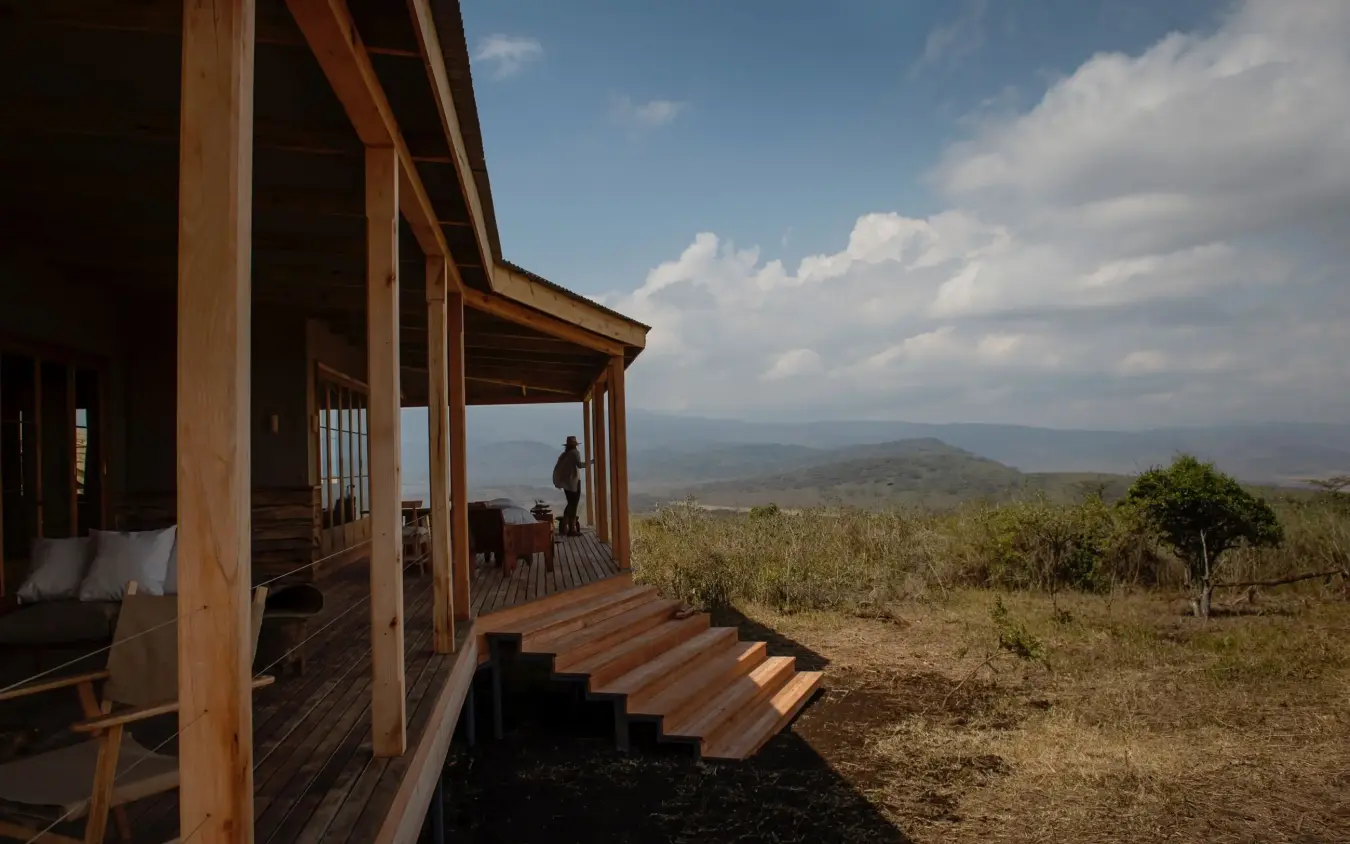 Wooden lodge terrace with valley and distant mountains view, Entamanu Private, Ngorongoro Crater, Tanzania