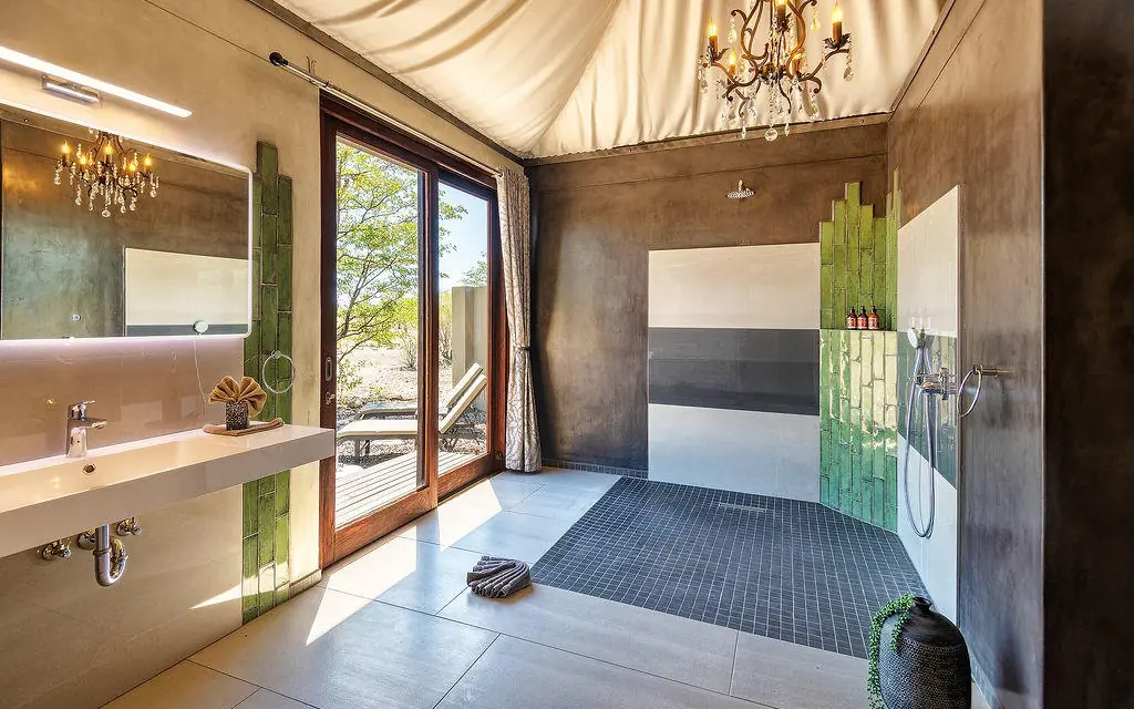 Modern bathroom with double vanity and outdoor shower access, Etosha Oberland Lodge, Etosha National Park, Namibia