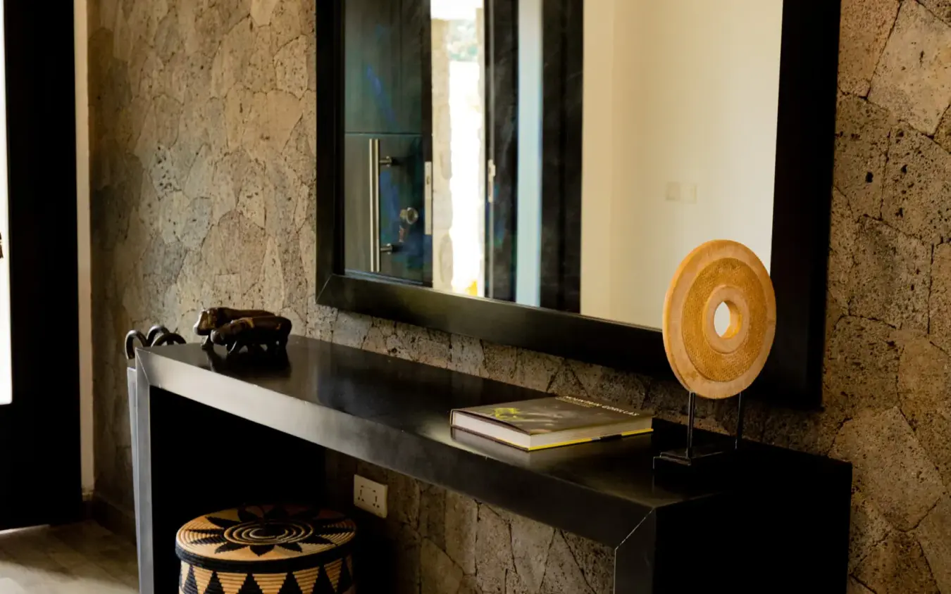 Black vanity with mirror and woven decorative baskets, Farmhouse Rwanda, Volcanoes National Park, Rwanda