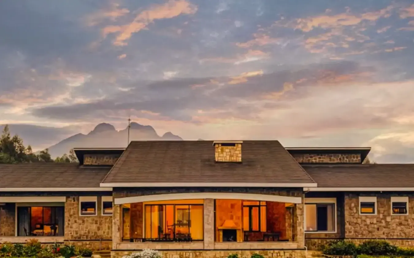 Stone farmhouse with warm lighting at golden hour sunset, Farmhouse Rwanda, Volcanoes National Park, Rwanda