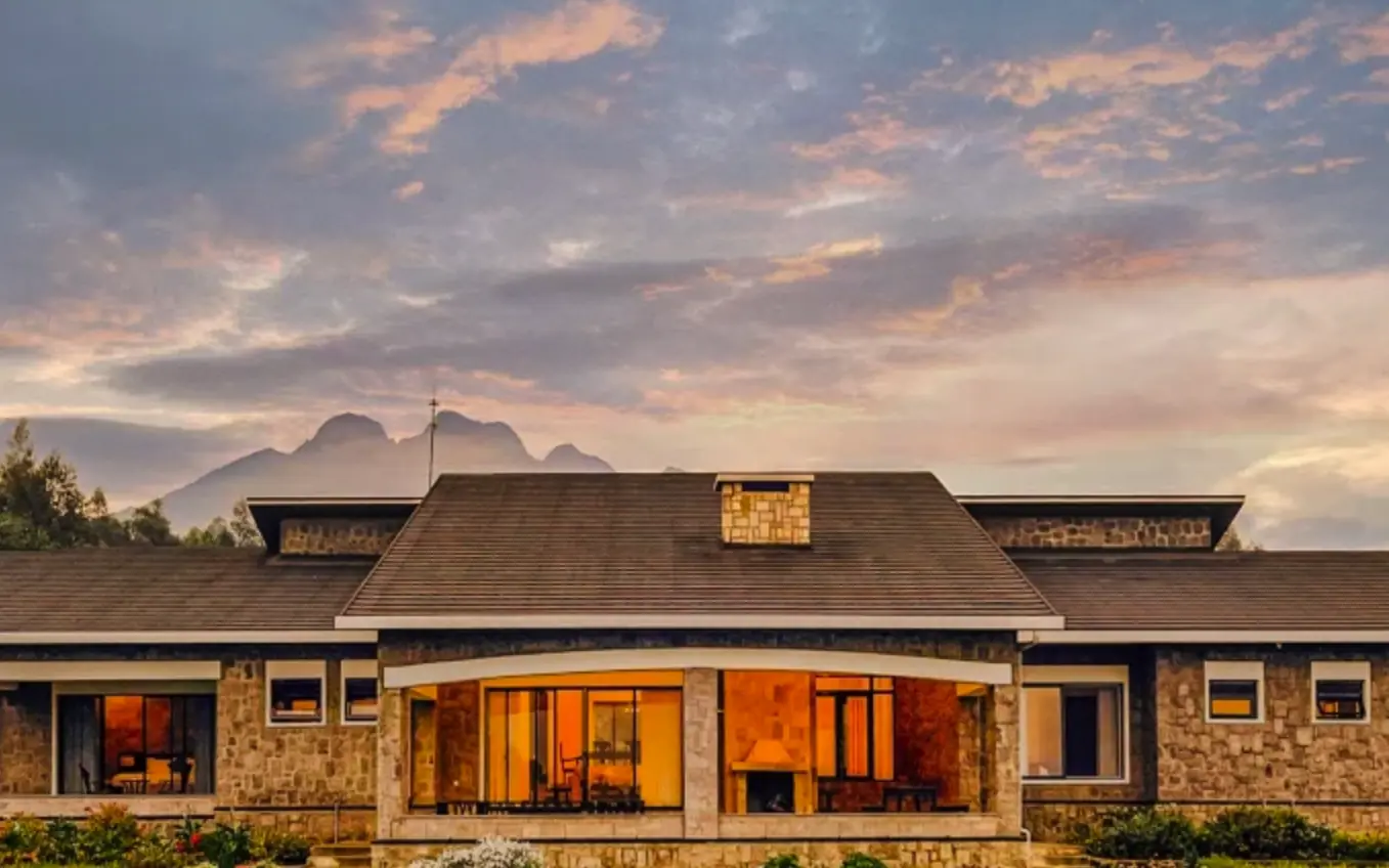 Stone farmhouse with warm lighting at golden hour sunset, Farmhouse Rwanda, Volcanoes National Park, Rwanda