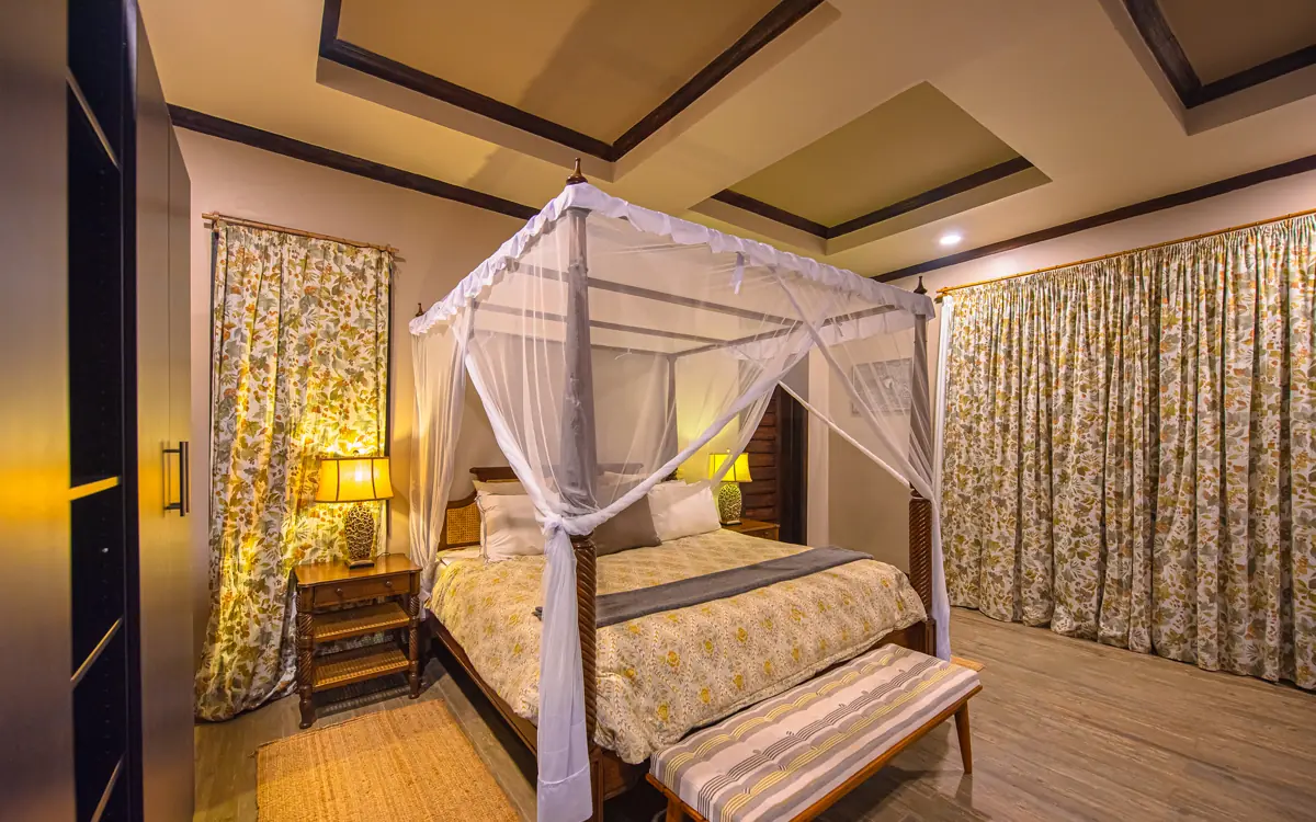 Luxurious bedroom with four-poster canopy bed and drapes, Five Volcanoes, Volcanoes National Park, Rwanda