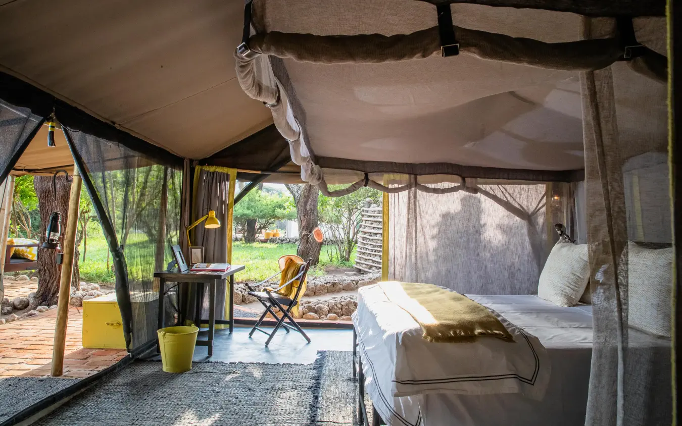 Canvas tent interior with bed and outdoor views, Forest Chem Chem, Lake Manyara, Tanzania