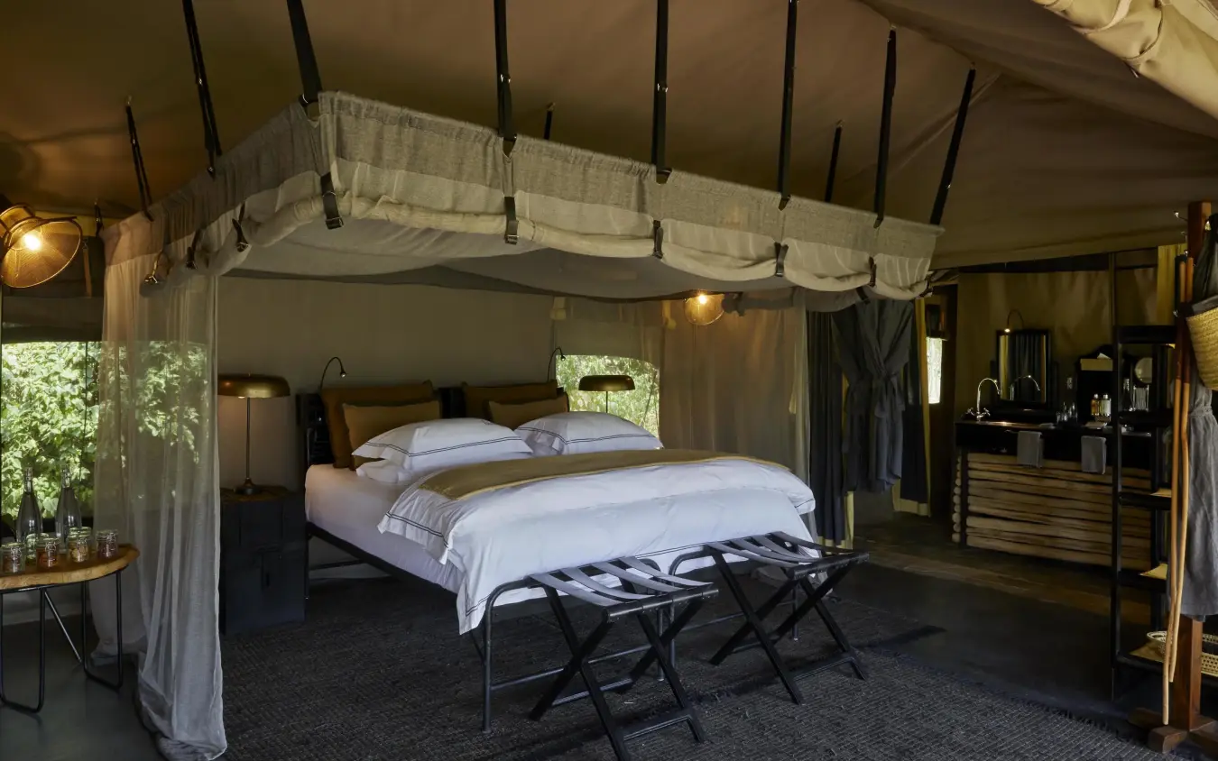 Luxury safari tent bedroom with canopy bed and furnishings, Forest Chem Chem, Lake Manyara, Tanzania
