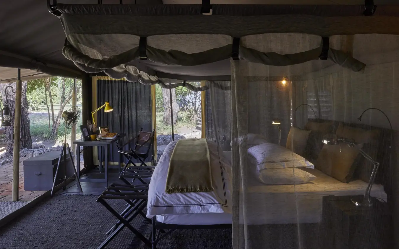 Safari tent bedroom with mosquito netting and forest views, Forest Chem Chem, Lake Manyara, Tanzania