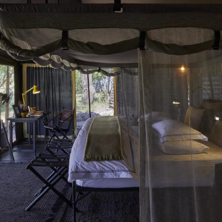 Safari tent bedroom with mosquito netting and forest views, Forest Chem Chem, Lake Manyara, Tanzania