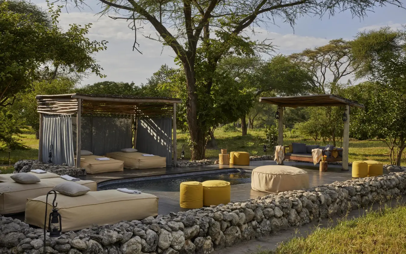 Outdoor pool area with loungers and stone walls, Forest Chem Chem, Lake Manyara, Tanzania