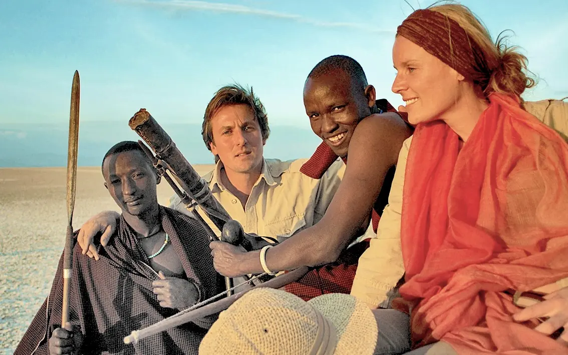 Group of people posing together in desert landscape, Forest Chem Chem, Lake Manyara, Tanzania