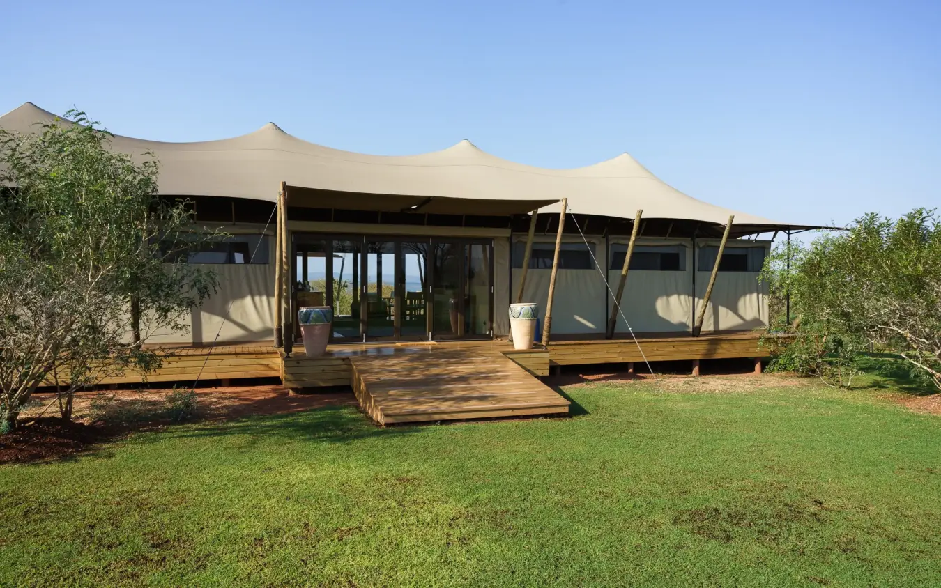 Luxury safari lodge with canvas tent structure and wooden deck on manicured grounds, Fothergill Island, Matusadona National Park, Zimbabwe