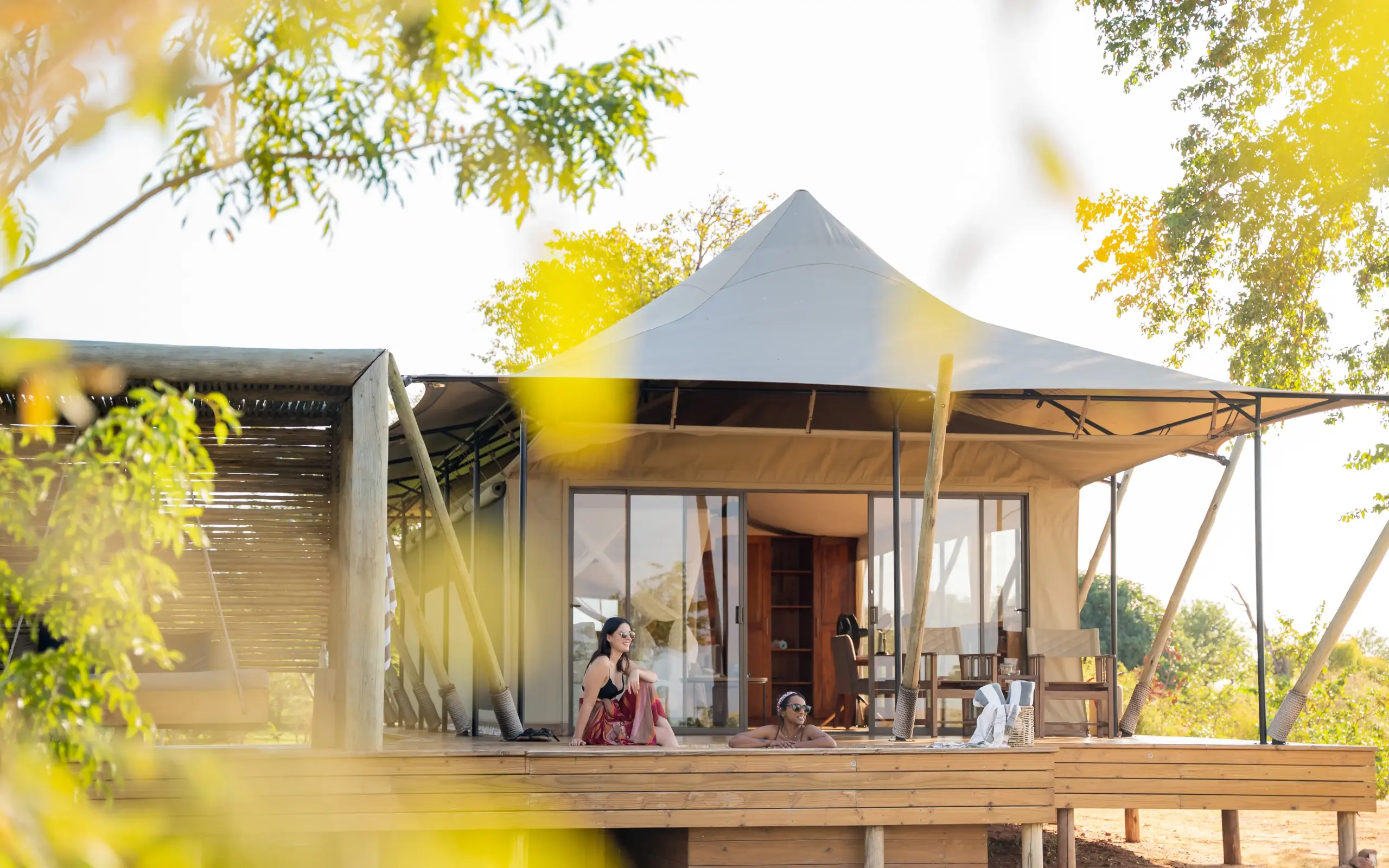 Luxury tent accommodation with wooden deck and shaded veranda overlooking landscape, Fothergill Island, Matusadona National Park, Zimbabwe