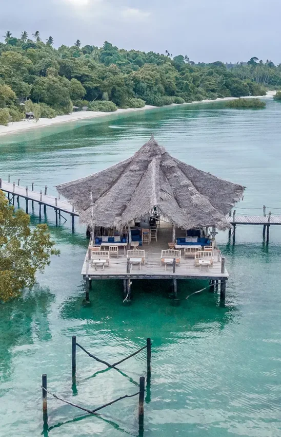 Overwater bungalow with thatched roof and wooden walkway, Fundu Lagoon, Zanzibar & Pemba, Tanzania