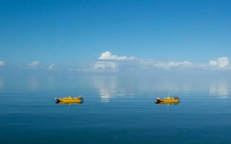 Two yellow fishing boats on calm turquoise water, Fundu Lagoon, Zanzibar & Pemba, Tanzania