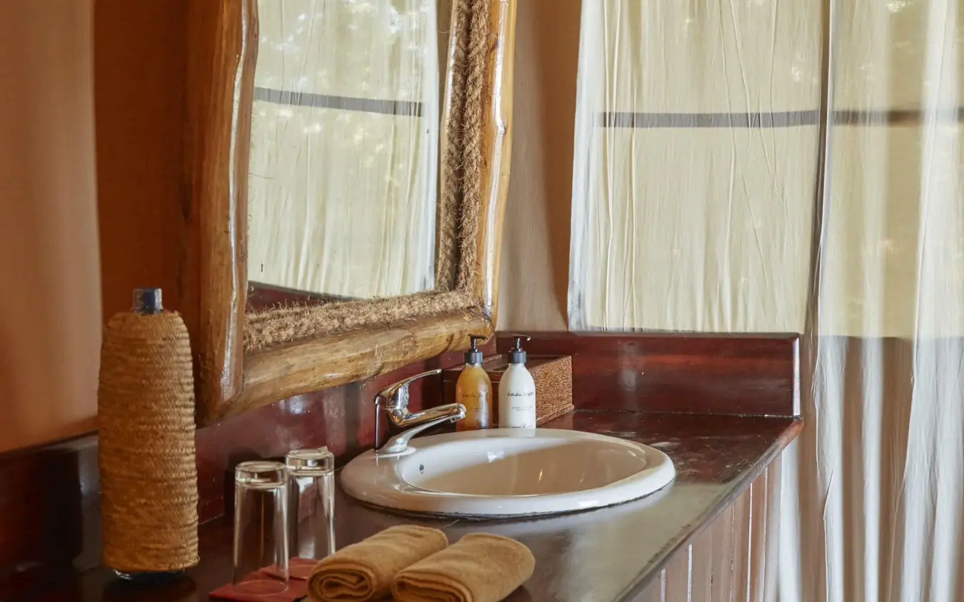 Bathroom sink with mirror and toiletries on counter, Fundu Lagoon, Zanzibar & Pemba, Tanzania