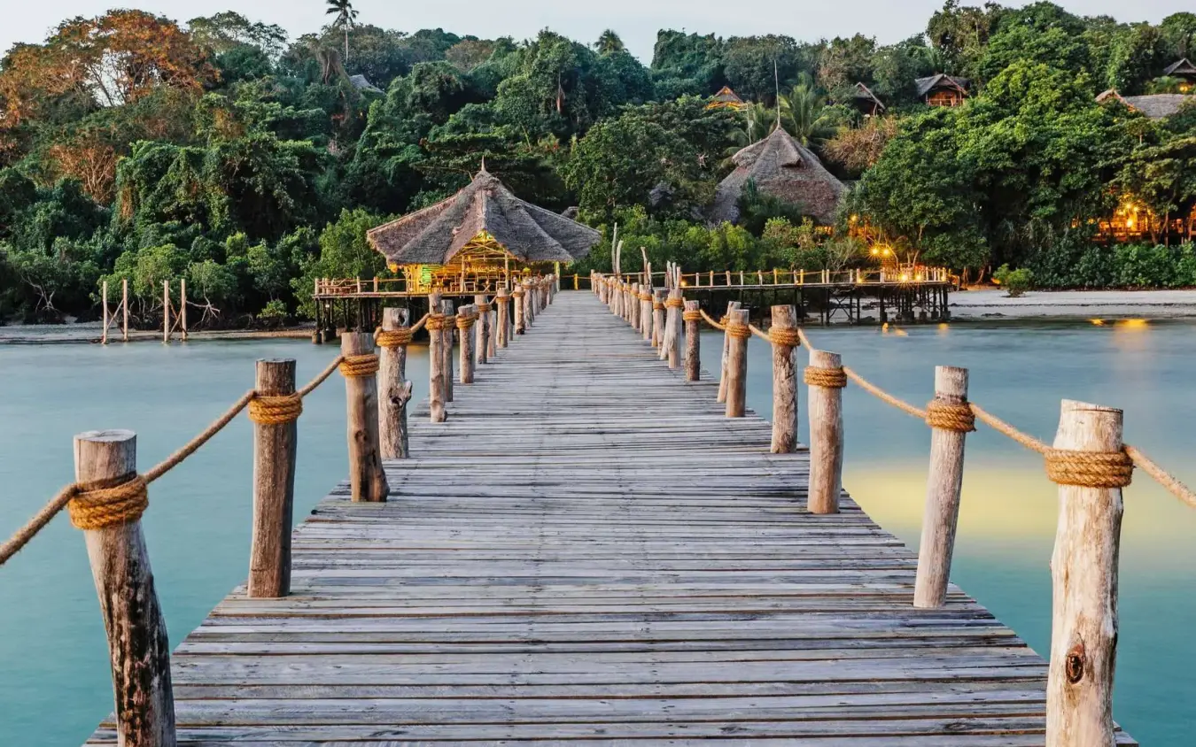 Wooden boardwalk pier extending into turquoise lagoon water, Fundu Lagoon, Zanzibar & Pemba, Tanzania