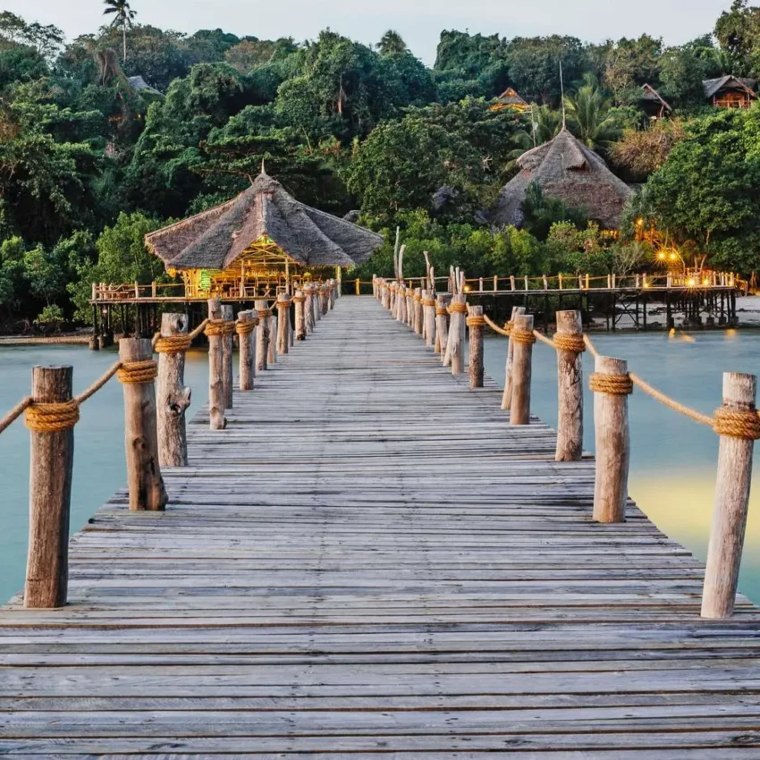 Wooden boardwalk pier extending into turquoise lagoon water, Fundu Lagoon, Zanzibar & Pemba, Tanzania