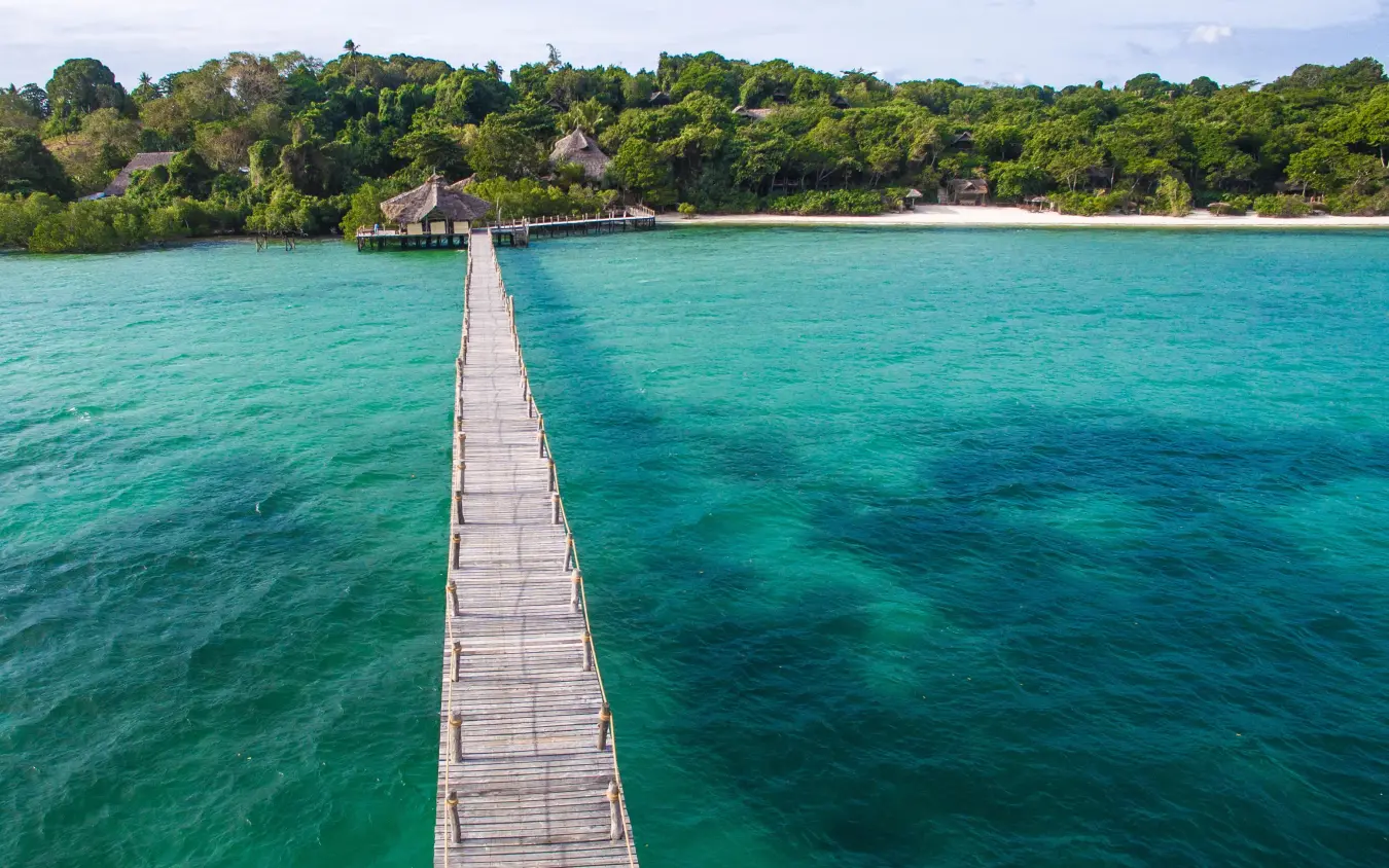 Wooden pier extending into turquoise lagoon water, Fundu Lagoon, Zanzibar & Pemba, Tanzania