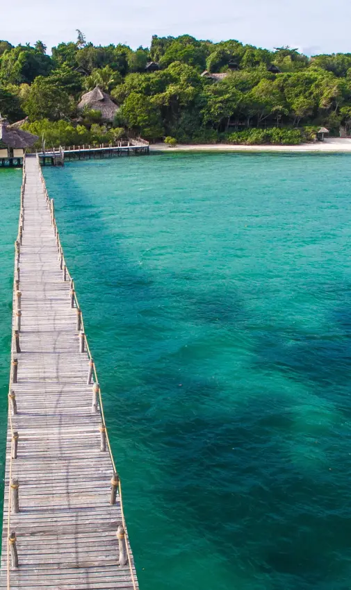 Wooden pier extending into turquoise lagoon water, Fundu Lagoon, Zanzibar & Pemba, Tanzania