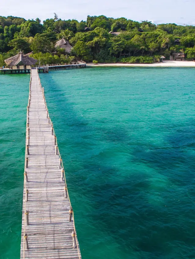 Wooden pier extending into turquoise lagoon water, Fundu Lagoon, Zanzibar & Pemba, Tanzania