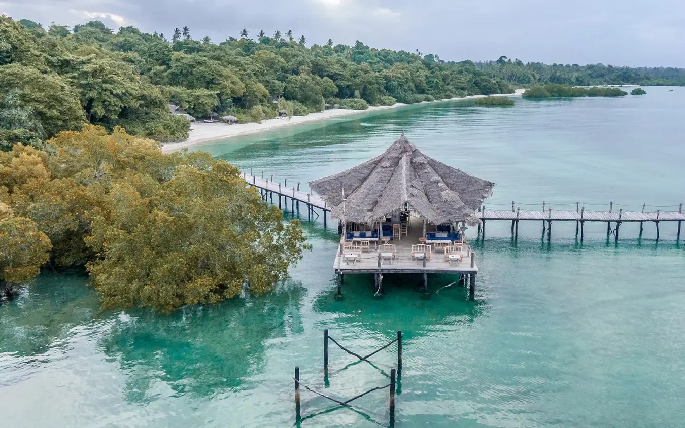 Overwater bungalow with thatched roof and wooden walkway, Fundu Lagoon, Zanzibar & Pemba, Tanzania