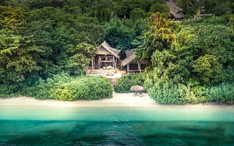 Beachfront lodge nestled among lush tropical vegetation, Fundu Lagoon, Zanzibar & Pemba, Tanzania