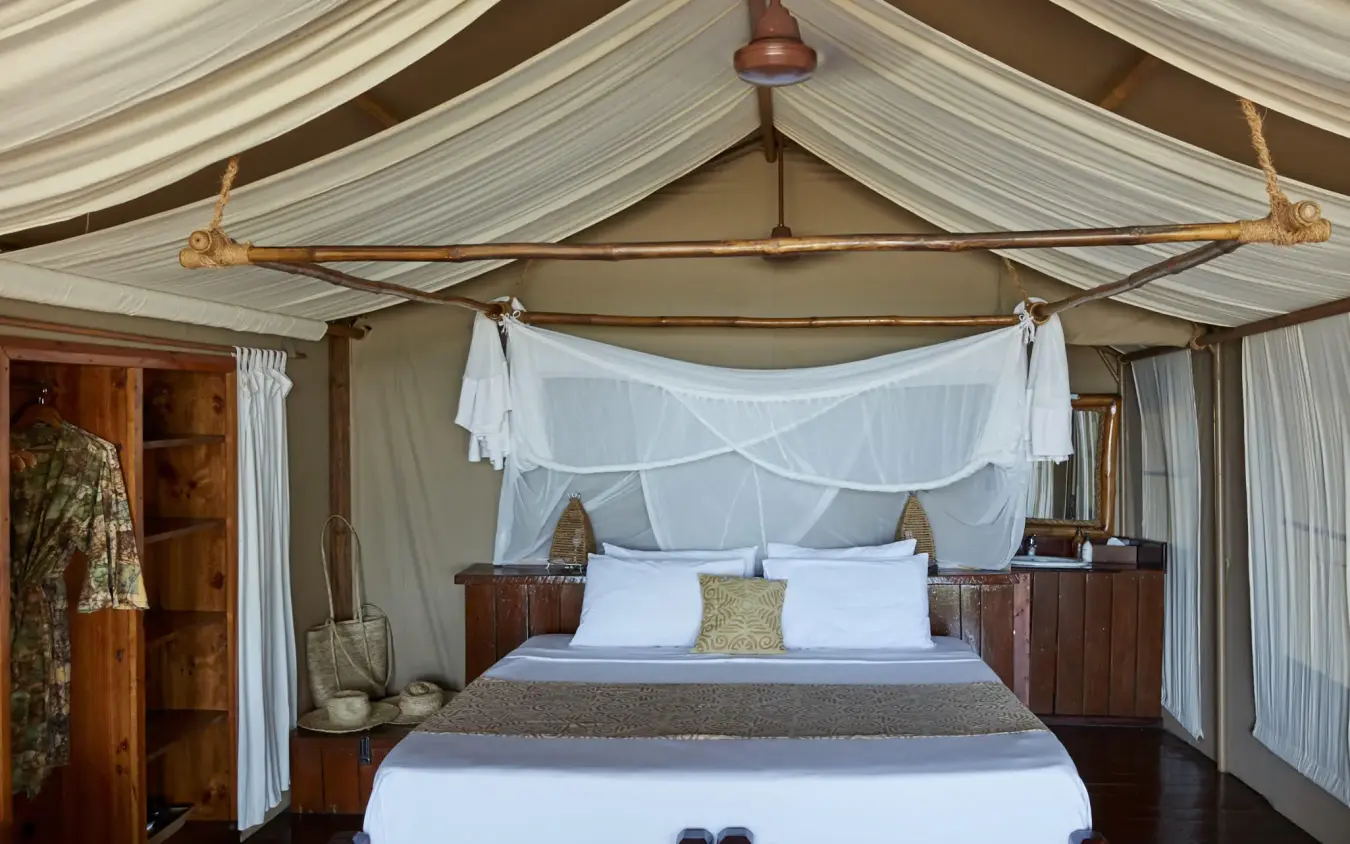 Luxury tent bedroom with four-poster bed and sheer canopy, Fundu Lagoon, Zanzibar & Pemba, Tanzania