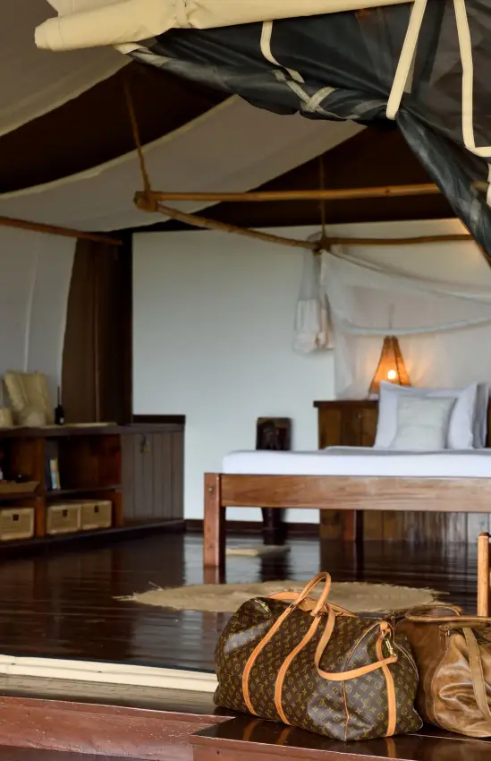 Luxury safari tent interior with bed and furnishings, Fundu Lagoon, Zanzibar & Pemba, Tanzania