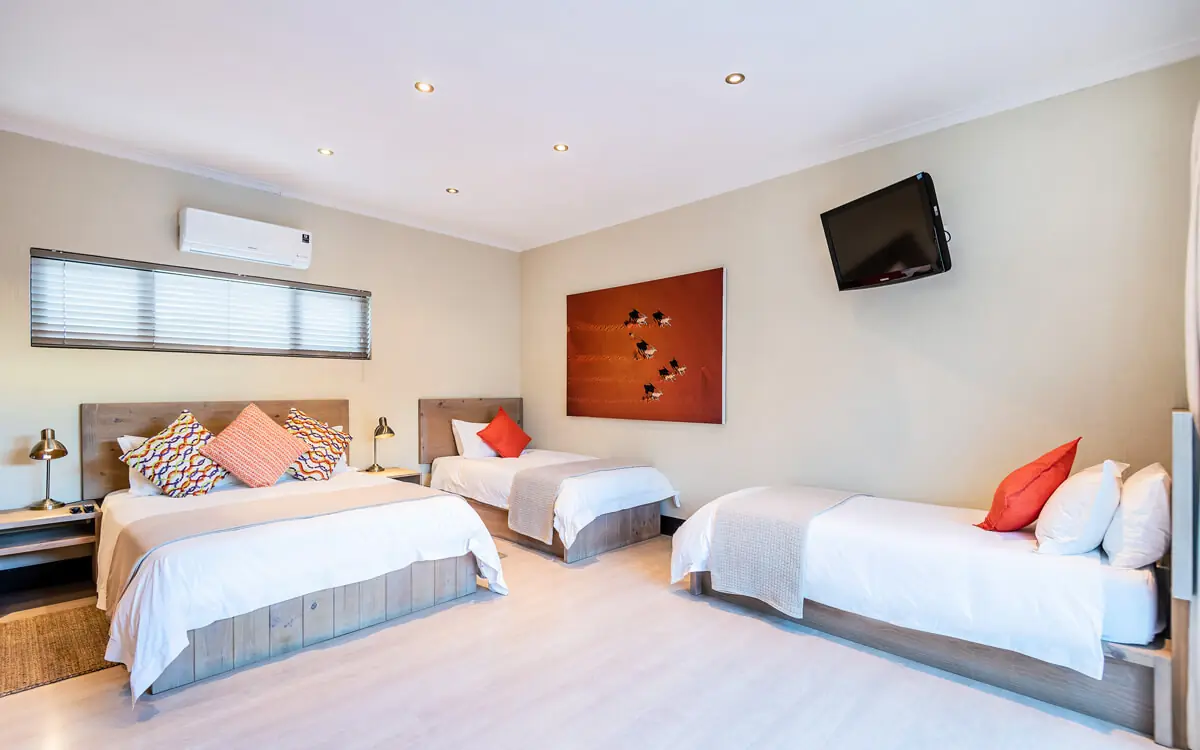 Spacious bedroom with multiple beds and modern amenities, Galton House, Windhoek, Namibia