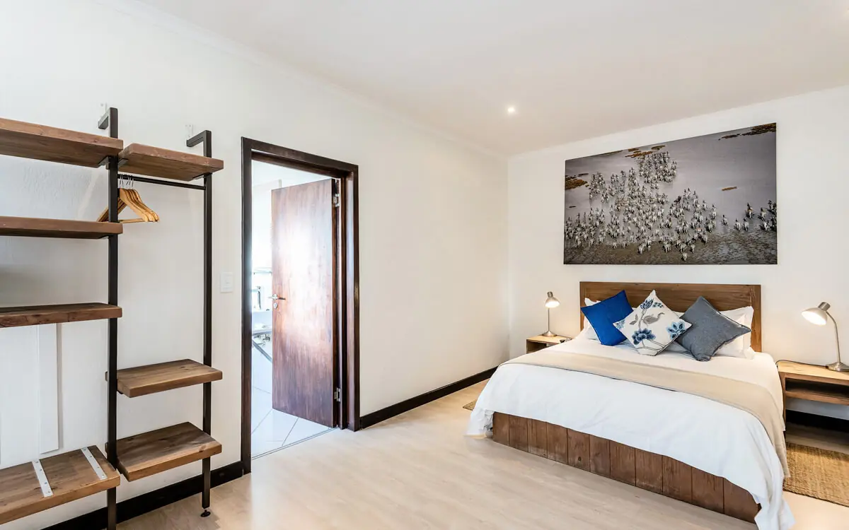 Modern bedroom with wooden bed frame and shelving, Galton House, Windhoek, Namibia