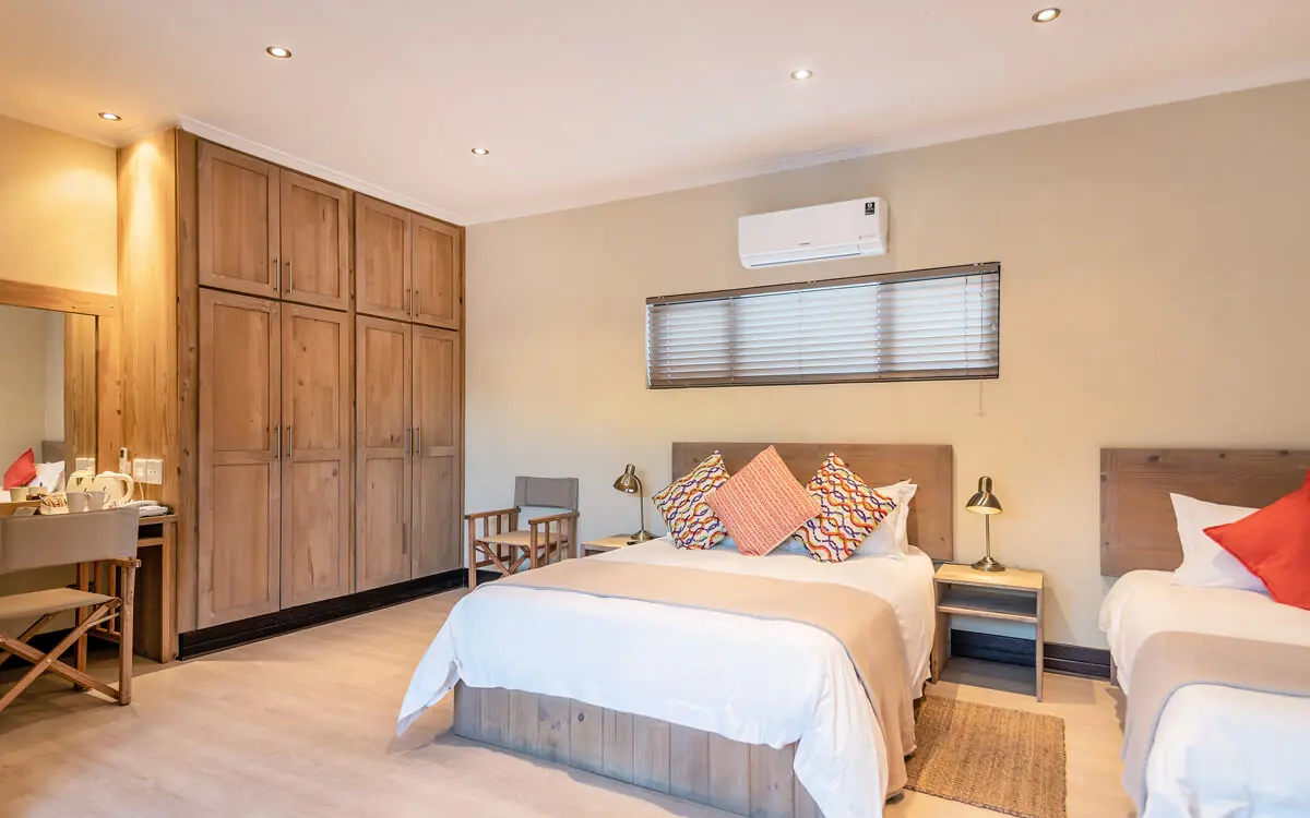 Spacious bedroom with dual beds and wooden wardrobe, Galton House, Windhoek, Namibia