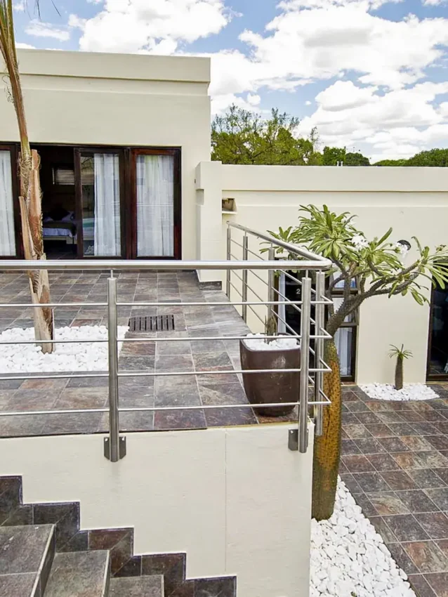 Modern lodge exterior with deck, railings, and landscaping, Galton House, Windhoek, Namibia