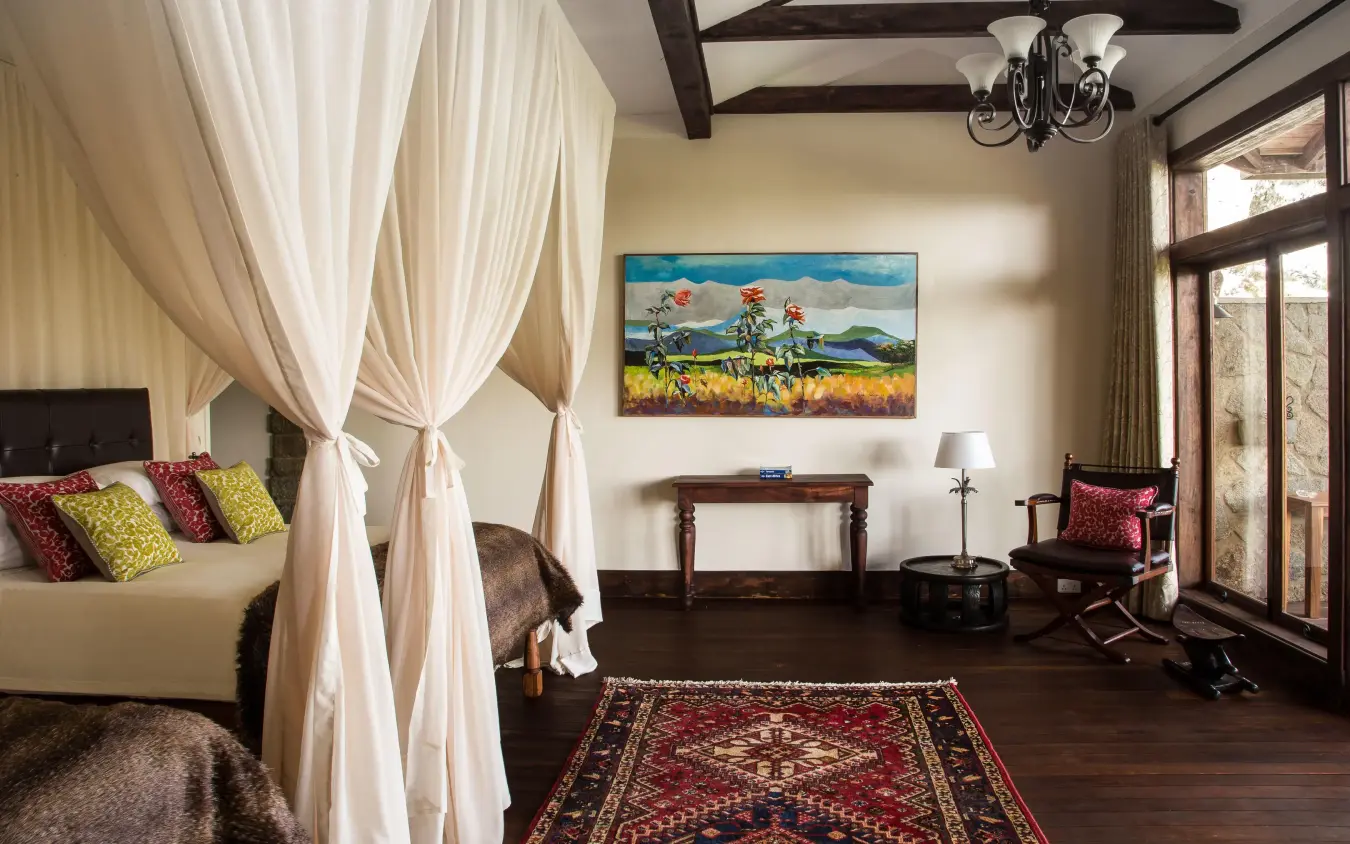 Spacious bedroom with canopy bed and large windows, Gibb’s Farm, Ngorongoro Crater, Tanzania