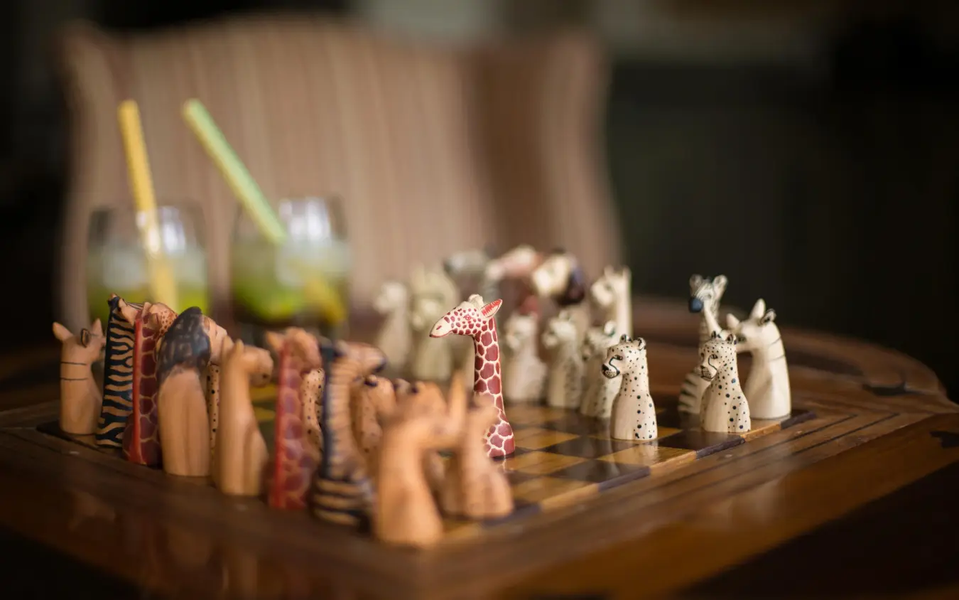 Hand-carved wooden chess set with animal pieces on board, Giraffe Manor, Nairobi, Kenya