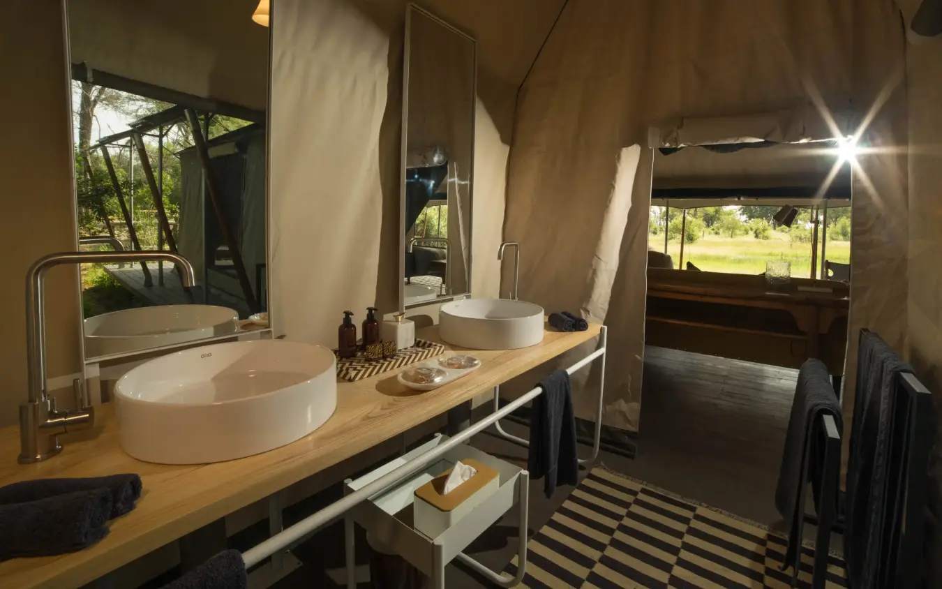 Luxury bathroom with double sinks and canvas walls, Gomoti Plains, The Okavango Delta, Botswana