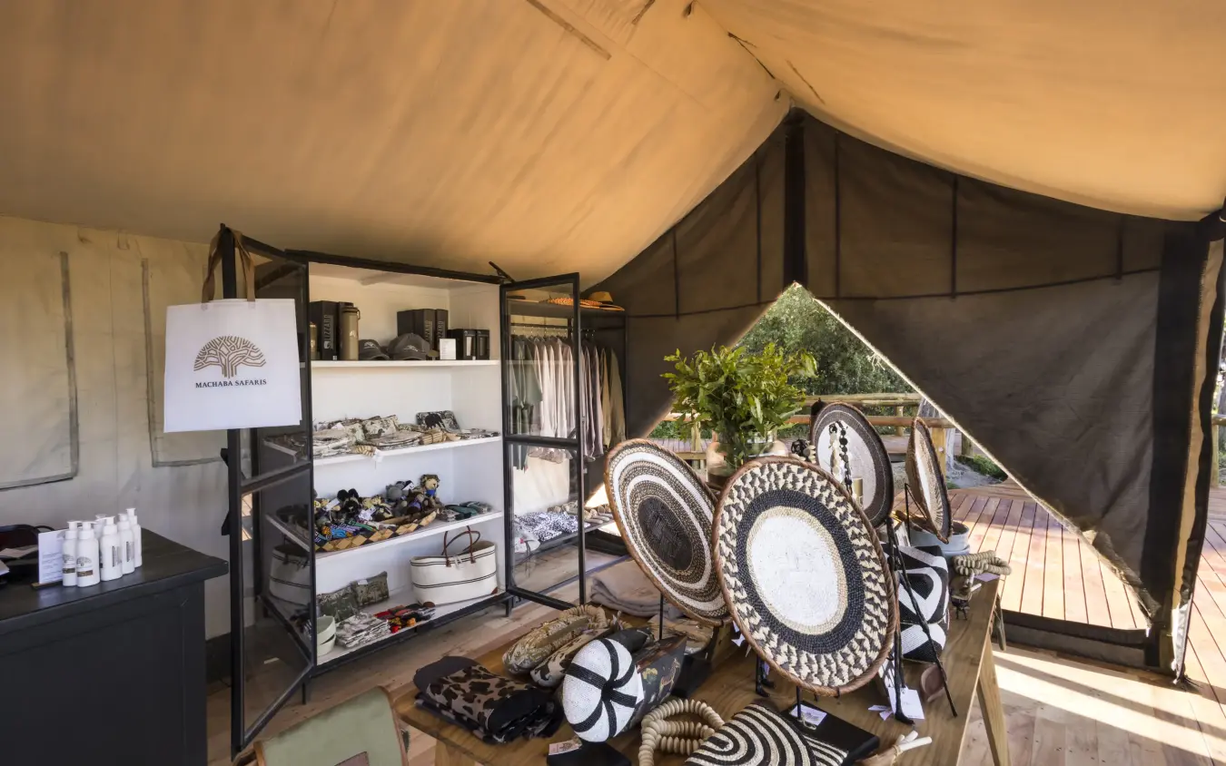 Interior view of curio shop with decorative plates and crafts, Gomoti Plains, The Okavango Delta, Botswana