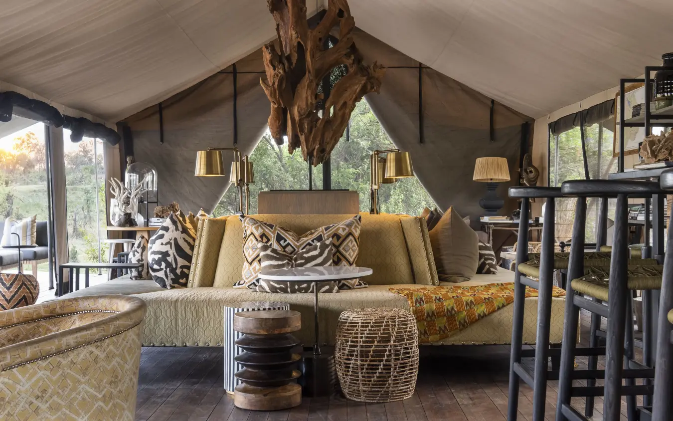 Luxury safari lounge with canvas tent ceiling and natural wood accents, Gomoti Plains, The Okavango Delta, Botswana
